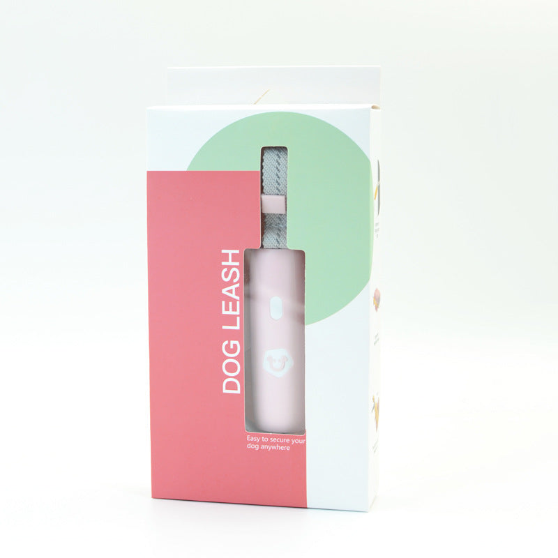 Dog leash packaging with pink and white design on a light gray background