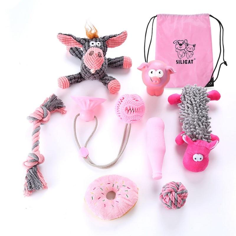 Collection of pet toys including a pink drawstring bag with 'Siligat' branding on a white background.
